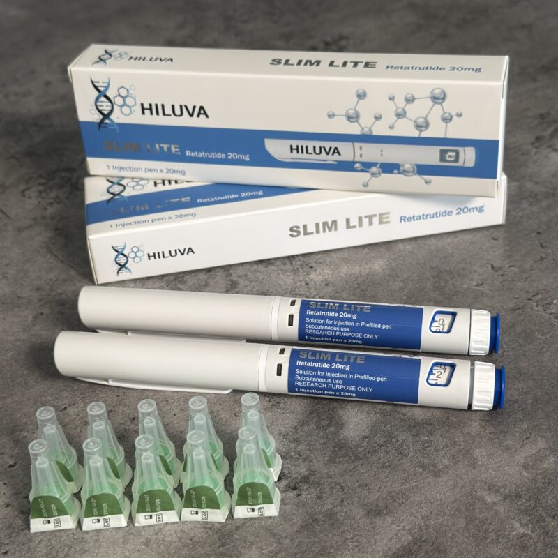 Two blue-and-white Hiluva Slim Lite boxes, two white pen-like applicators with blue ends, and five small green ampoules laid out on a gray surface.